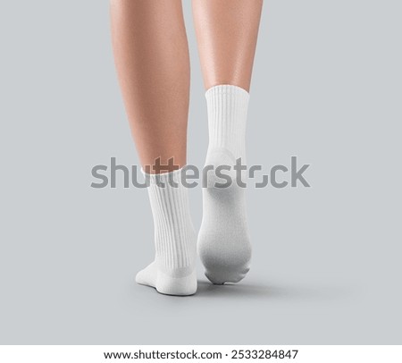 Mockup of white medium socks on women's legs, stretched toes, gaiters with space for design, branding, advertising, front view. Template apparel for foot, isolated on background. A pair of sportswear