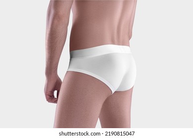 Mockup Of White Men's Panties With A Wide Elastic Band On The Guy's Shaved Body, Close-up, Underpants Isolated On The Background, Back, Side. Template Of Male Clothing, Sportswear, Swimwear For Design