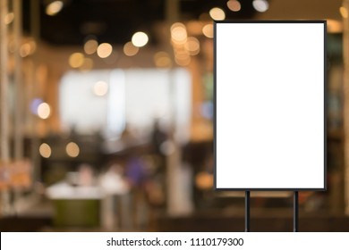 mockup white poster with black frame stand in front of blur restaurant cafe background for show or present promotion product concept