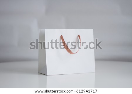 Mock-up of white shopping bag on neutral background