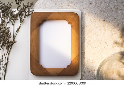 Mockup Wooden Photo Frame On Round Stone Table With Evening Sunlight