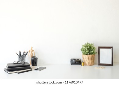 Mockup workspace desk and copy space books,plant and coffee on white desk. - Shutterstock ID 1176913477