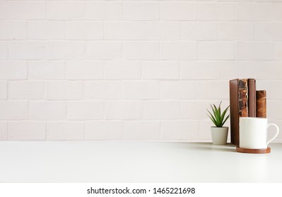 Mockup Workspace Desk And Copy Space Books,plant And Coffee On White Desk.