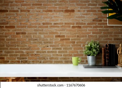 Mockup Workspace Vintage Books, Dry Flower, Office Stationery And Cork Frame Over Red Brick Wall.