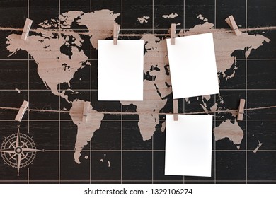 Mockup of the world map with three white blank paper on a rope clothespin