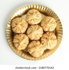 modak, indian festival sweet dish Modak, made from flour and coconut jaggery filling. Modak is a traditional Indian sweet made during Ganesh Utsav and also offered to lord Ganesha. - Shutterstock ID 2180770143