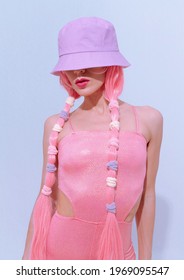 Model 90s Party Hip-hop Style Posing In White Studio. Trendy Pink Jumpsuit, Bucket Hat And Pink Hair. Fashion Unicorn Lady Vibes