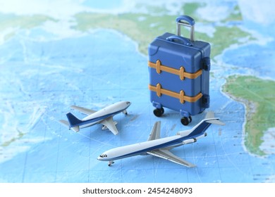 A model of an airplane departing for an overseas trip and a world map - Powered by Shutterstock