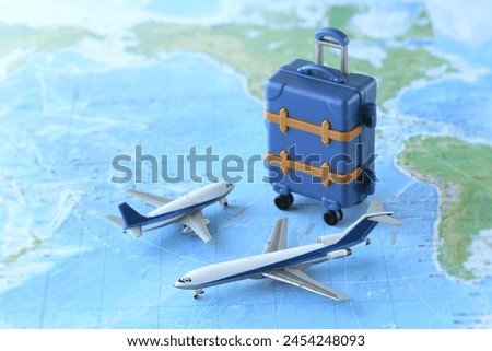 A model of an airplane departing for an overseas trip and a world map
