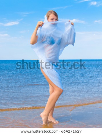 Similar – Young woman walks on the beach