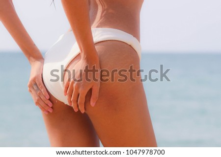 Model in a bikini at the beach.