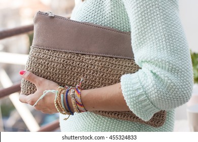 Model With Bracelets Holding A Purse