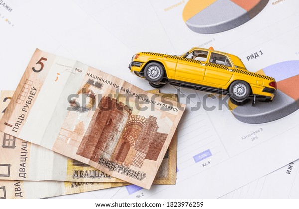 Model of car on background of coins,\
concept of car loan, car insurance, leasing, transport tax.\
Belarusian money, Minsk, February 25, Belarus\
2019\
\
