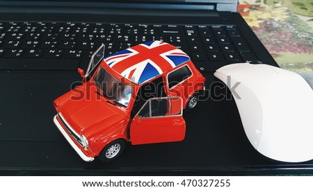 model car on the Keyboard. red Model car , red car open two door . 
