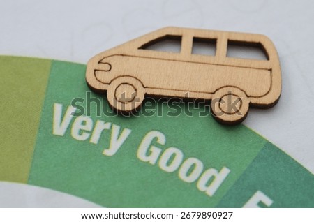 A model car rests on a document in the "Very Good" section of a rating chart, symbolizing a top-tier inspection report, high safety score, or positive consumer feedback.