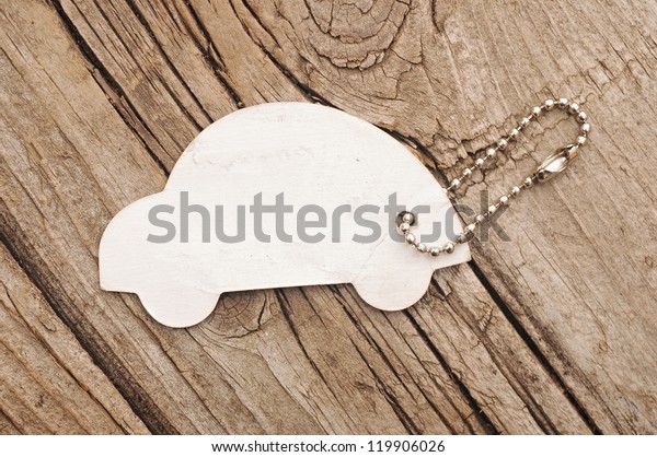 model car with silver chain on old wood background.\
space for your text