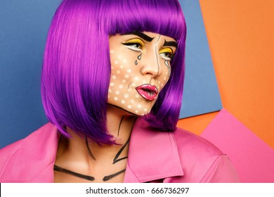 Model In Creative Image With Pop Art Makeup Against Colorful Background