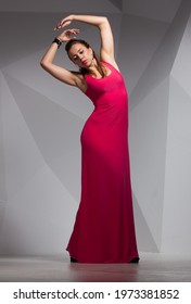 Model In A Crimson Dress In A Stylish Interior With Space For Text.