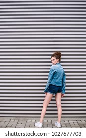 Model In Denim Jacket On Striped Background