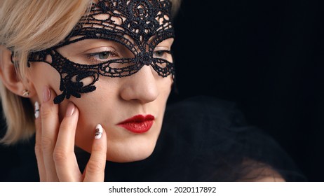 A model dressed in a masquerade ball costume for the fancy costume party. Wearing A Venetian Masquerade Mask and red lipstick. Closeup headshot. Mysterious girl wearing a lace Masquerade mask. - Powered by Shutterstock