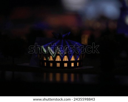 Model of the dwelling of the northern peoples. Lights are burning in the windows on a dark night