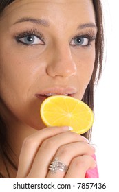 model eating an orange slice upclose