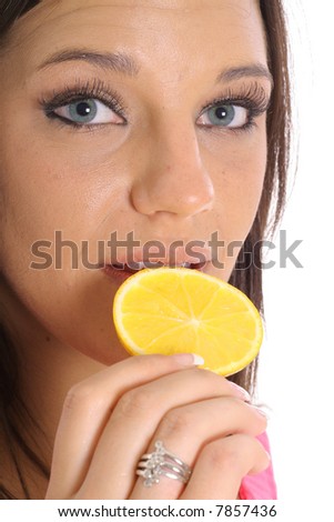 model eating an orange slice upclose