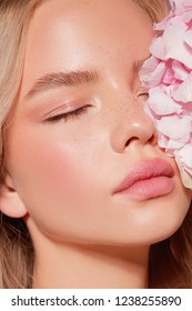 Model With Flower. Perfect Make Up. Beauty. Pink Background. Cosmetics. Skin Care.