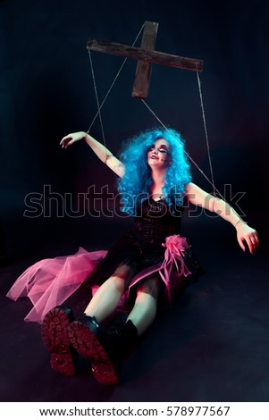 model in form of puppet doll with ropes and straps for puppet master