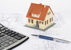 Model house and calculator on construction plan of a house construction, an Industrial Photo by Nifolwight
