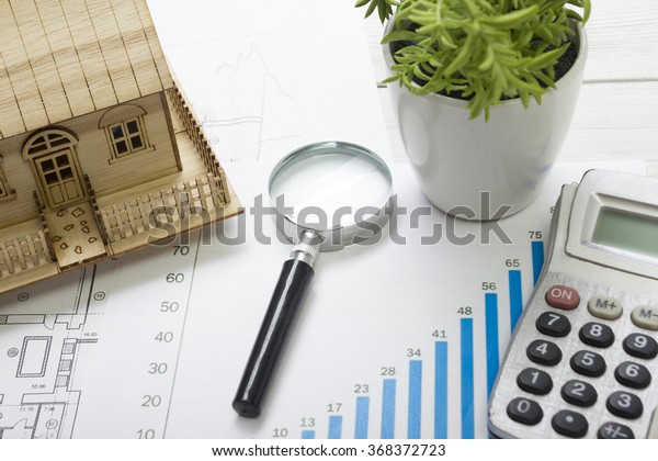 Model
house, construction plan for house building, magnifying glass
compass. calculator. Real Estate Concept. Top
view.