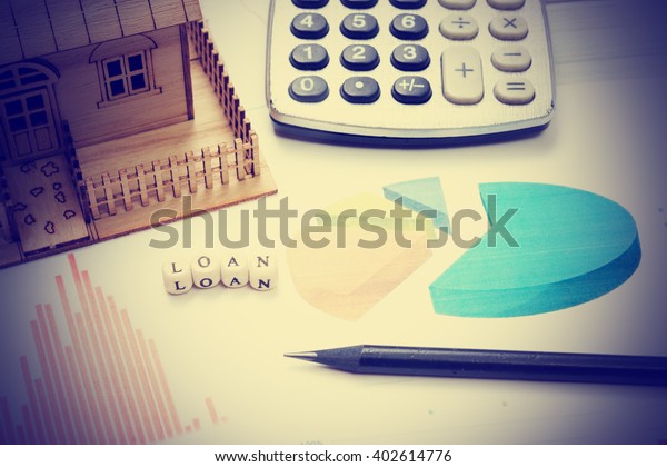 Model house, construction plan\
for house building, calculator. Real Estate Concept. Top\
view.