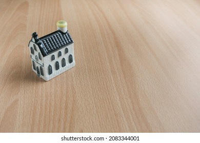 A Model Of A House On The Wooden Table. Chrominance Noise Like Is Visible Due To The Texture Of The Subjects