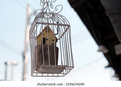 Model House Trapped In A Birdcage The Concept Of Building A House Is Hindered.