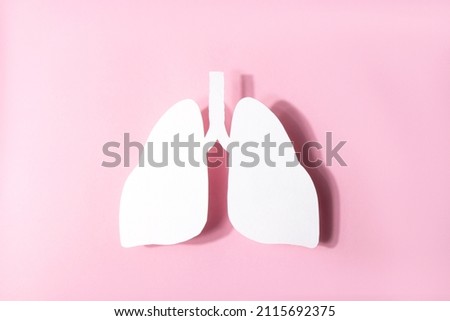 Model of a human lungs shaped white paper on a pink background. Lung Health Day. World Pneumonia Day