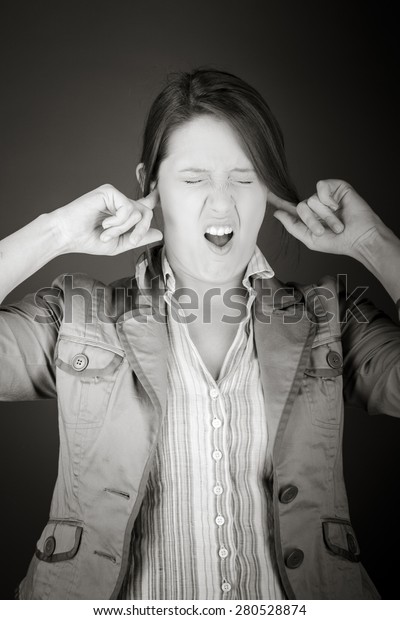 model isolated on plain background plugging ears\
with fingers