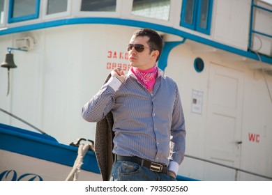 a model man staring in the background a ship, boy in glasses
