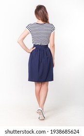 Model In A Navy Blue Skirt And A Striped Blouse On A Light Background.