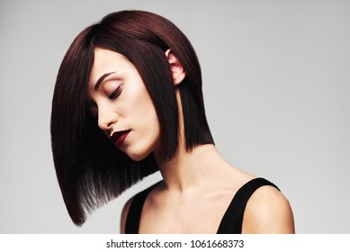 Model with perfect long glossy brown hair. Close-up Bob haircut portrait