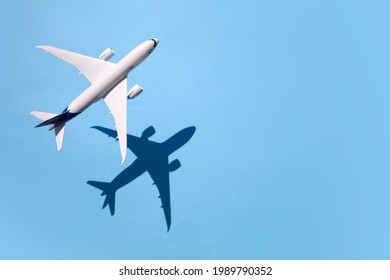 Model plane, airplane on sky blue background with deep shadow