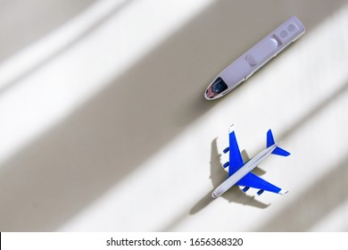 Model Plane And Bullet Train On Yellow Pastel Color Background With Shadow. Miniature Toy Airplane And Train. Top View, Flat Lay, Copy Space. Concept Of Travel And Vacation.