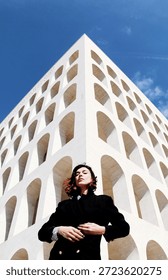 the model posing in front of the camera in front of a period building