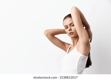 Model posing gracefully with arms raised, conveying elegance and confidence against a clean white background, highlighting beauty and simplicity