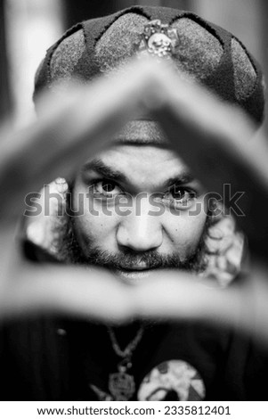 Model posing looking through hands