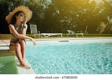 Model Posing Next to Swimming Pool in garden