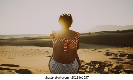 model posing on the beach in silhouette and backlight