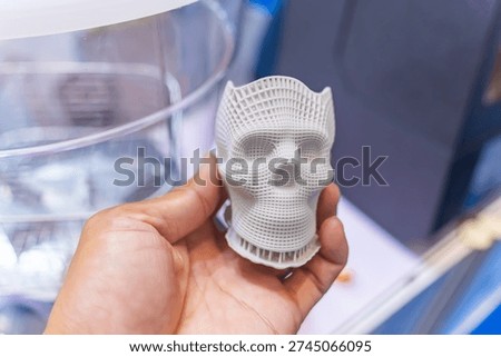 model printed on 3d printer in form of colorful muscles of the face with human hand,additive technologies and futuristic concept