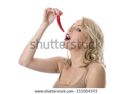 Model Released. Attractive Young Woman Eating a Red Hot Chilli Pepper
