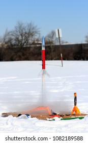 A model rocket being launched in the wintertime.
