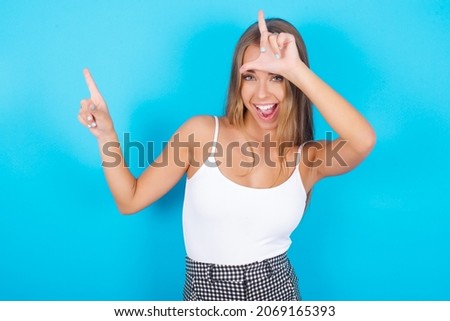 MODEL showing loser sign and pointing at empty space